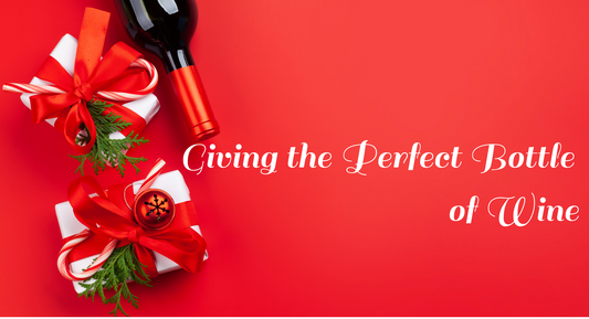 Wine bottle and presents red background with text Giving the Perfect Bottle of Wine